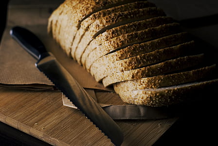bread knife beside baked bread thumbnail