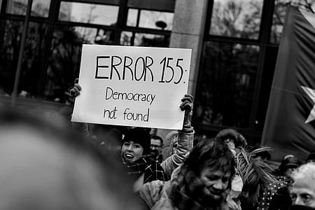 person holding Error 155: Democracy Not Found banner thumbnail