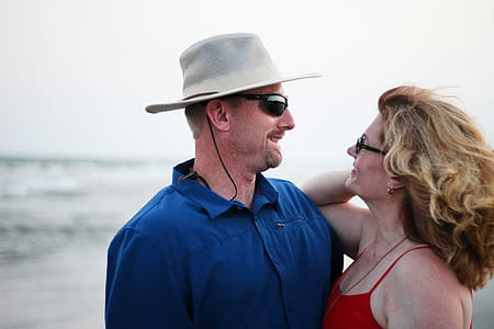 selective focus photography of man and woman on beach thumbnail