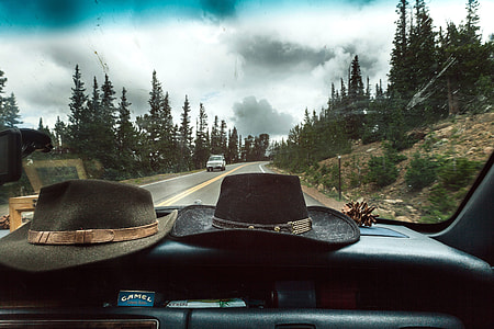 two black and brown cowboy hats on black dashboard thumbnail