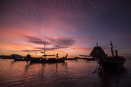silhouette photography of person on boat thumbnail