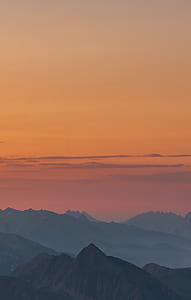 mountains during orange sunset thumbnail