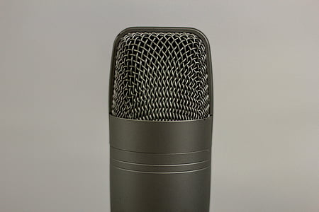 black microphone close-up photo in white room thumbnail