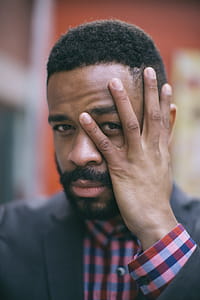 Selective Focus Photography of Man Holding His Face thumbnail