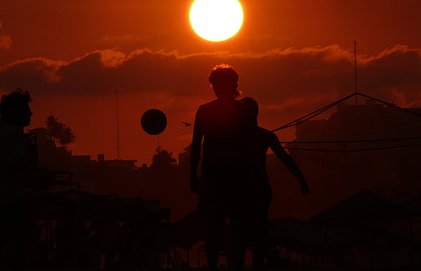 silhouette photo of two person under red sun thumbnail