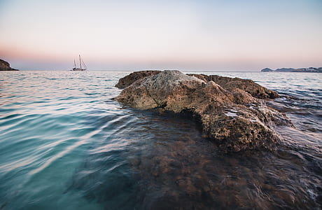 close view of rock in calm waters thumbnail