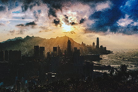 Bird's Eye View of City Near Ocean During Sunset thumbnail