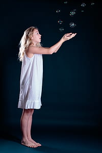 girl wearing white tank dress raising hands with bubbles on air thumbnail