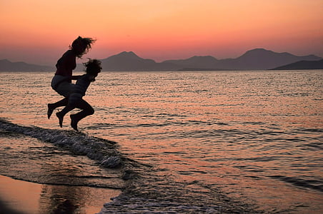 silhouette of person while jumping on shore thumbnail