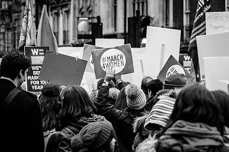 grayscale photography of group of people protesting while holding banner thumbnail