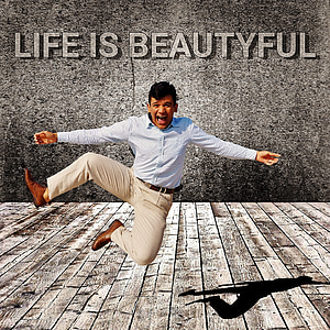 man in white dress shirt and brown dress pants jumping with Life is beautiful text overlay thumbnail