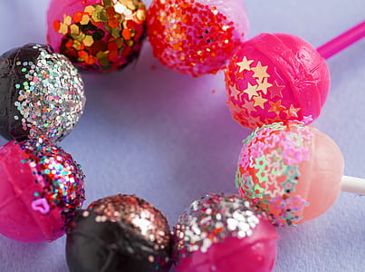 assorted-flavor lollipops on white surface thumbnail