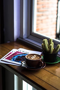 green cactus beside cafe latte served on brown ceramic cup thumbnail