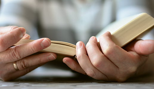 selective focus photography of person reading book thumbnail