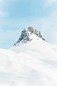 brown mountain covered with white snow at daytime thumbnail