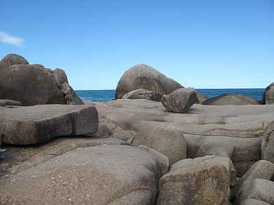 brown rock formation near seashore at day time thumbnail