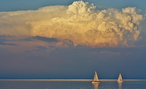 two white sailboats on body of water under cumulus clouds thumbnail
