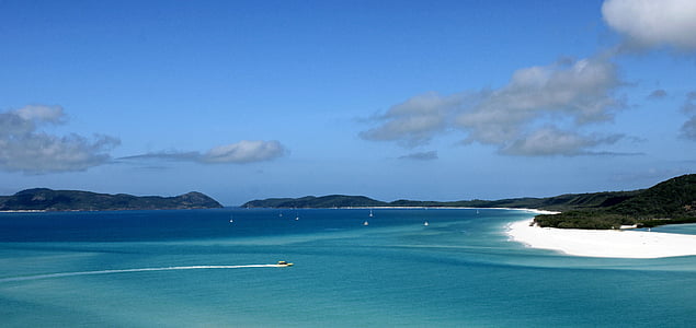 boat sailing on body of water under blue sky thumbnail
