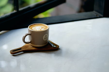 gray ceramic teacup filled white coffee latte thumbnail