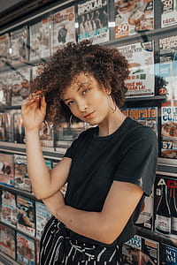 woman in black crew-neck T-shirt holding hair thumbnail
