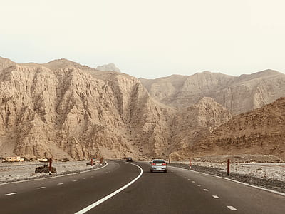 gray car on road near mountain at daytime thumbnail