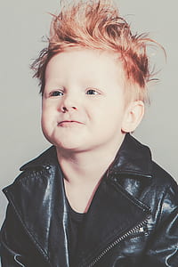 boy wearing leather biker jacket smiling for a photo thumbnail