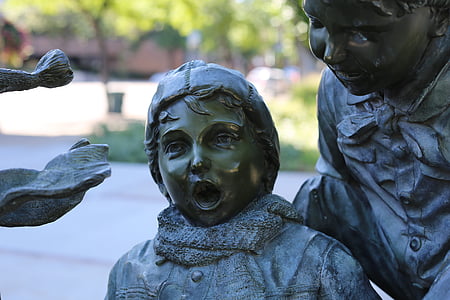 selective focus photography of toddler statue thumbnail
