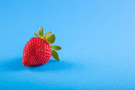 red strawberry on blue surface thumbnail