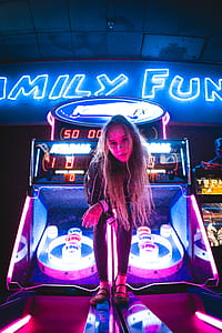 woman standing on arcade machine thumbnail