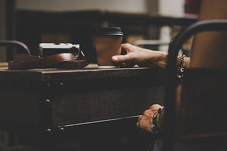 person holding disposable cup thumbnail