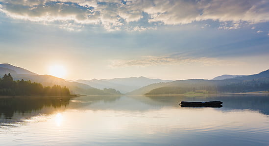 raft in middle of body of water during golden hour thumbnail