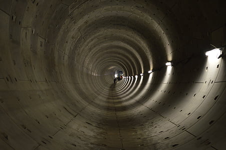 gray concrete tunnel with lights turned on thumbnail