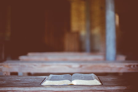 open book page on brown wooden table thumbnail