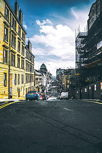 Vehicle Parked on Street Between High Rise Buildings thumbnail