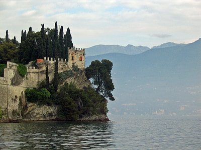 brown stone castle on cliff near body of water during daytime thumbnail