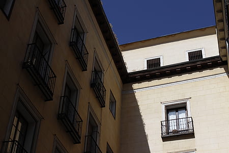 beige concrete building under blue skies thumbnail