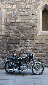 black standard motorcycle parked beside wall thumbnail