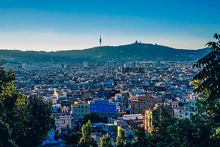 aerial photo of city with background of mountain thumbnail