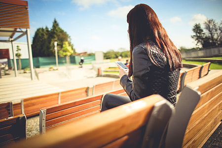 Girl Using her iPhone Outside thumbnail