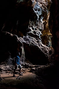 man standing between stones thumbnail