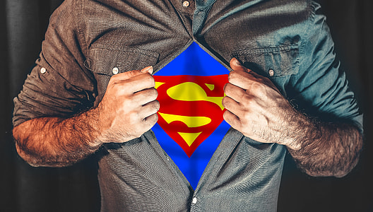 man opening his shirt showing a superman symbol on his inner shirt thumbnail