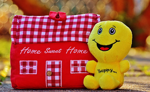 yellow plush toy beside red handbag thumbnail
