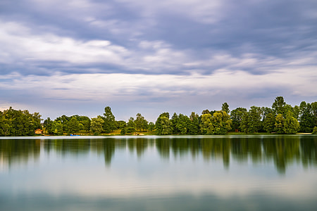 body of water surrounded by trees thumbnail