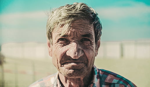 smiling man outdoors selective focus photography thumbnail