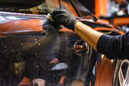 person wearing black hand glove photography thumbnail