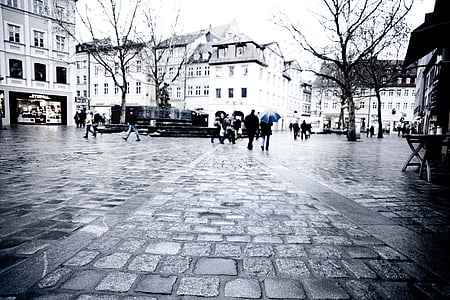 woman walking on street with umbrella during daytime thumbnail
