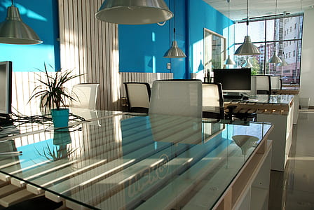 clear glass top dining table with white chairs thumbnail