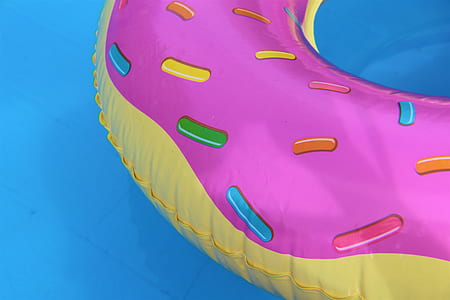 pink and yellow inflatable on body of water thumbnail