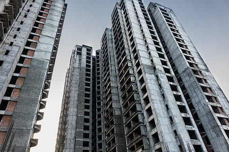 worm's-eye view photography of high-rise building under cloudy sky thumbnail