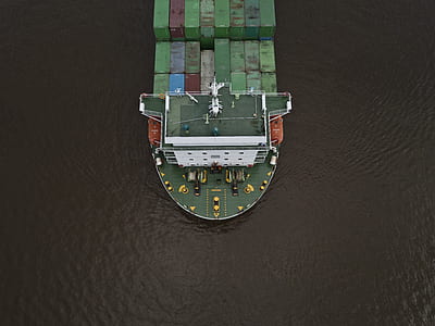 aerial photography of green and white ship on ocean during daytime thumbnail